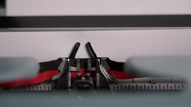 Close-up of a vintage typewriter printing the word Hello on paper. The scene represents a new beginning, introduction, and the start of a story with a nostalgic retro atmosphere.