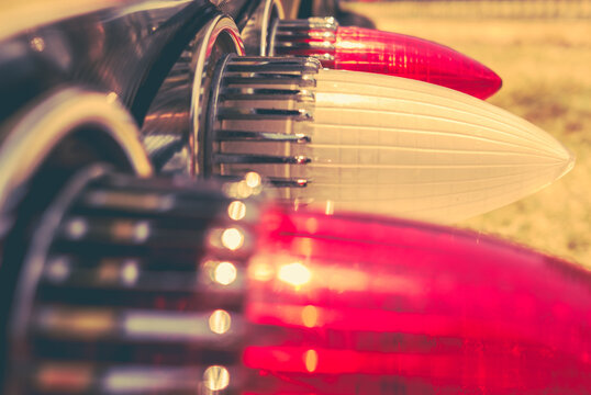 Close up of a vintage American car's plastic and metal, pointy tail lights evokes memories of lost youth and easier times - horizontal