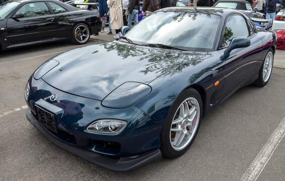 Dark blue Mazda RX-7 (FD) known for its organic, timeless design is celebrated as one of the most beautiful and technically advanced sports cars of the 1990s