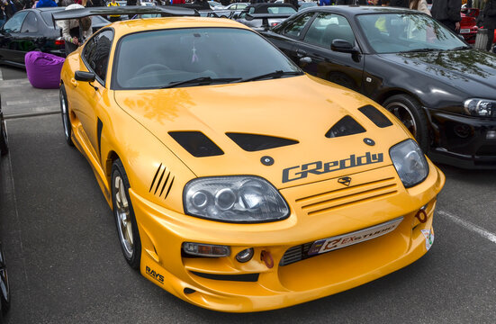 Yellow Toyota Supra A80 (Mark IV), produced between 1993 and 2002 and is most famous for its robust 3.0L inline six engine and its driver focused, cockpit style interior