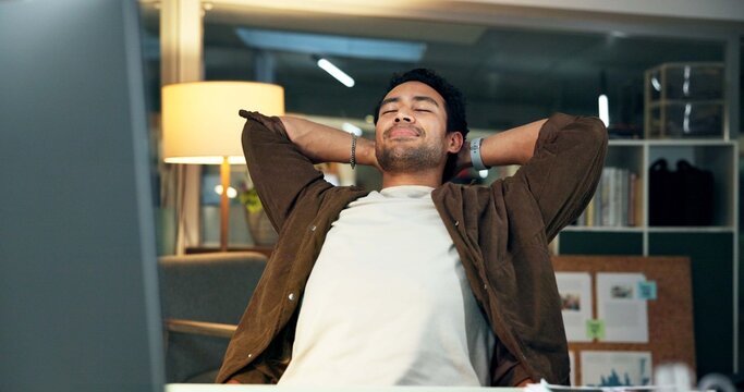 Night, man and stretching in office with computer, fatigue and finish news report for productive day. Late, writer and person relax in workplace with desktop, article submission and complete project.