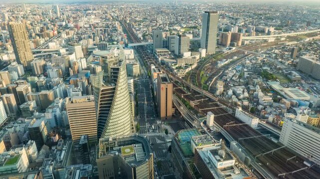 Central business district roads and railways cityscape skyline of Nagoya city, Japan. Aerial view time lapse video from day to night.