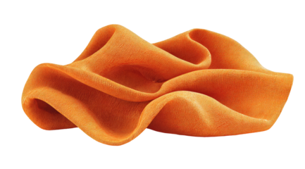 A detailed studio shot of flowing, ruffled orange fabric against a black backdrop