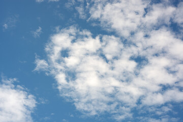Scattered Fluffy White Clouds in Vibrant Clear Blue Sky