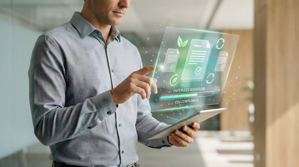 Man managing paperless workflow and ESG compliance on futuristic holographic tablet interface
