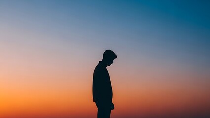 Man Standing Against a Vibrant Sunset