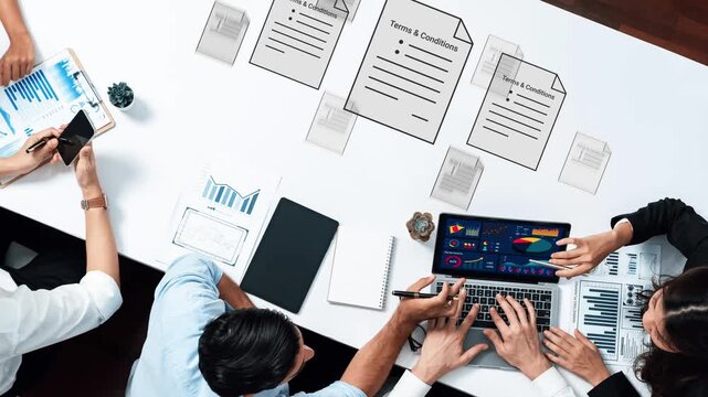 Modern Business Meeting with Laptops, Graphs, and Documents on Table, Collaboration and Strategy Development in a Professional Workspace Gluon.