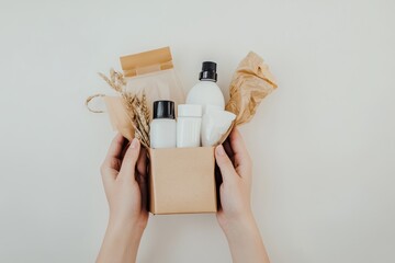 Hands holding a box filled with eco-friendly refill store essentials, showcasing sustainable products and natural materials for a zero waste lifestyle