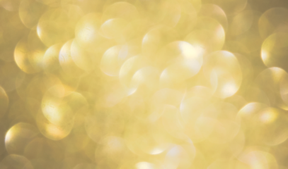 Luxury gold bokeh with soft glitter and magical sparkles. Bright firework effect with festive confetti on black background. Perfect for Christmas, celebration or New Year themes.
