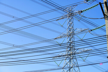 Fototapeta premium Power Lines and Transmission Tower Under Clear Blue Sky Landscape