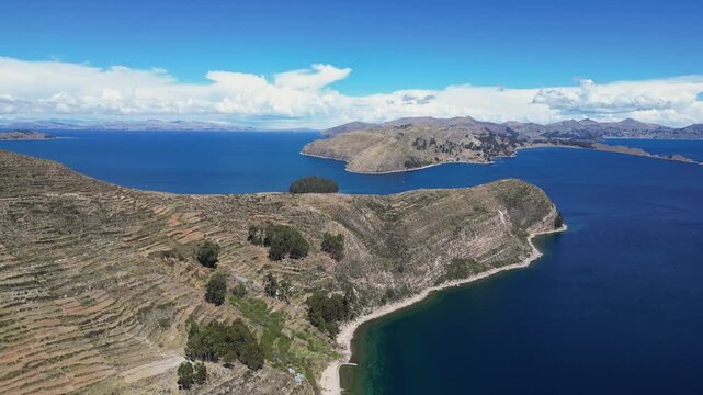Isla del Sol, Bolivia: Aerial drone footage of the Isla del sol, the sun island, on the lake Titicaca in the Andes with Copacabana and the mainland in the background in the Bolivia