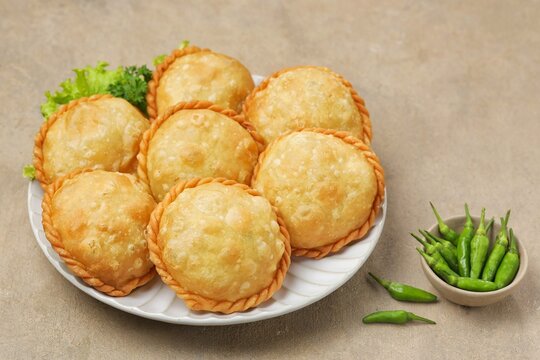 Pastel goreng, curry puff, karipap or empanadas shaped round
