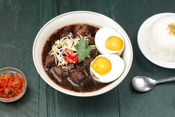 Rawon is a typical Indonesian dish originating from Ponorogo, East Java, which is a black meat soup with a mixture of special spices using kluwek.