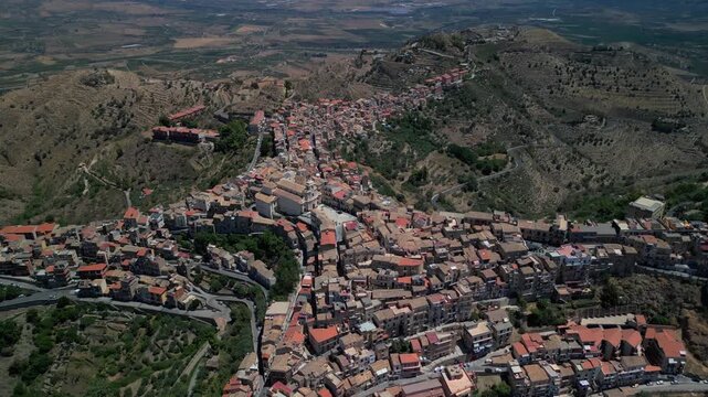 Wide cinematic drone shot of Centuripe with Mount Etna silhouetted against the evening sky.Aerial drone view highlighting the scale of Sicily&rsquo;s interior landscapes around Centuripe.