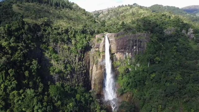 Cinematic drone footage of Diyaluma Waterfall, Sri Lanka&rsquo;s second highest falls, captured from a distance with a smooth orbit shot. Perfect for travel films, nature documentaries,scenic aerial project