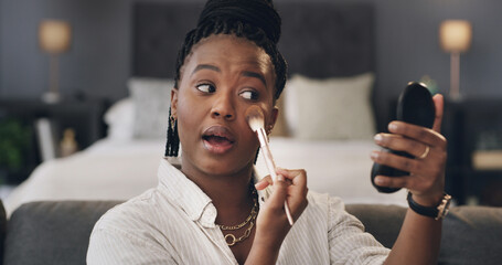 Black woman, mirror and makeup brush in bedroom with cosmetics, foundation or concealer at apartment. African person, beauty and eyeshadow for facial transformation, powder and application at house