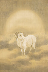 White ram standing in golden misty field at sunrise with soft backlight glow