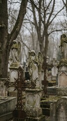 Fototapeta premium Old angel statue in a gravestone field. Cemetery with mournful angel sculpture, religion and memory concept for funeral memorial card.