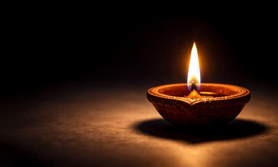 A lit Diya or Indian oil lamp on a dark background, Symbol of Diwali festival and Indian traditional festivals