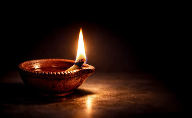 A lit Diya or Indian oil lamp on a dark background, Symbol of Diwali festival and Indian traditional festivals