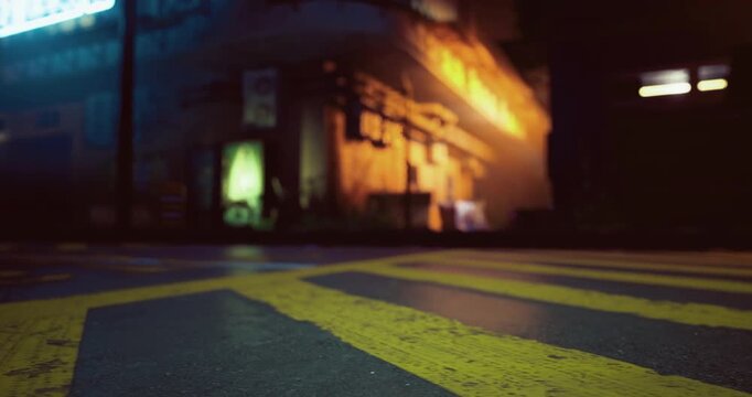 A vibrant urban street at night features wet pavement reflecting neon signs. Buildings are illuminated with colorful lights, enhancing the lively atmosphere of the city.
