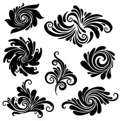 Fototapeta premium Collection of black ornate floral swirls and leaves in a decorative arrangement viewed from directly above