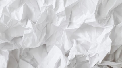 Obraz premium A close-up of crumpled white paper, showcasing its textured folds and shadows, creating an abstract and minimalist appearance.