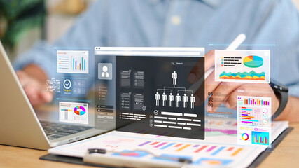 Business professional analyzing data analytics dashboard with charts, reports and AI interface on tablet and laptop. Concept of business intelligence, data analysis and digital transformation.