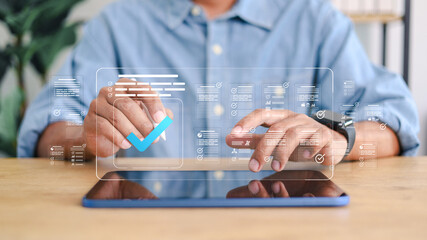Businessman approving digital documents on tablet with check mark interface. Concept of workflow management, quality control, approval process and digital transformation.