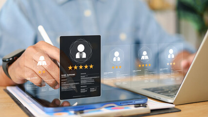 Business professional evaluating employee profiles with AI rating system and star scores on digital tablet. Concept of AI recruitment, talent management, HR analytics and performance evaluation.