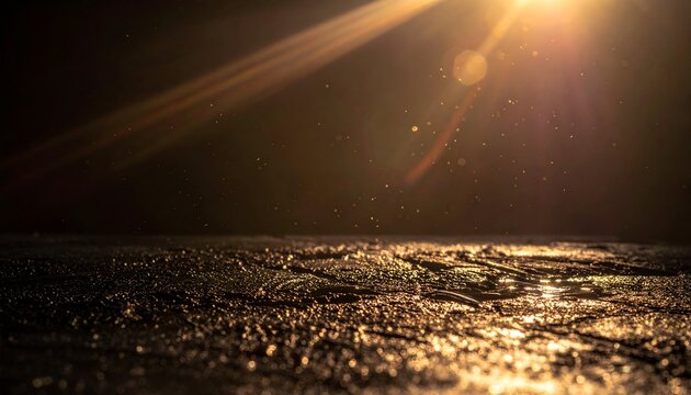 A sunburst illuminates a rough, reflective surface with particles floating in darkness