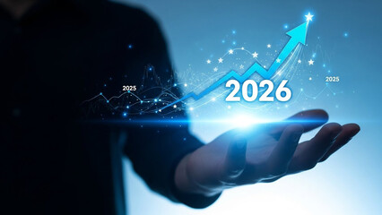 A person holds a glowing blue arrow pointing upwards with the year 2026 in their hand, symbolizing growth and progress.