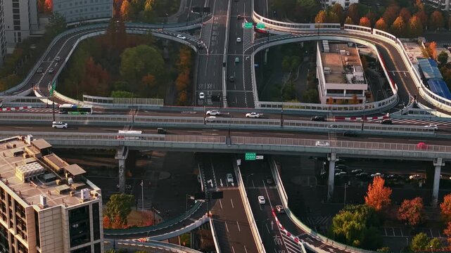 Aerial view of multilevel highway interchange with car and bus traffic in China during the sunset