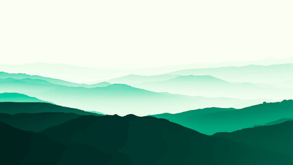 A misty morning mountain landscape features a serene valley view under a hazy blue sunrise sky with forest silhouettes and clouds rolling over the hills at dawn