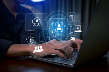 Business professional using laptop with holographic cybersecurity interface, digital shield, data protection icons, cloud security, and user authentication concept for modern technology and informatio