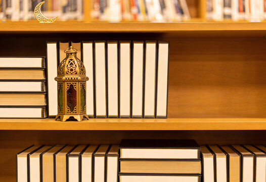 Ramadan: Ramadan Lantern and Crescent Moon Decor on Bookshelf with Books graphic design