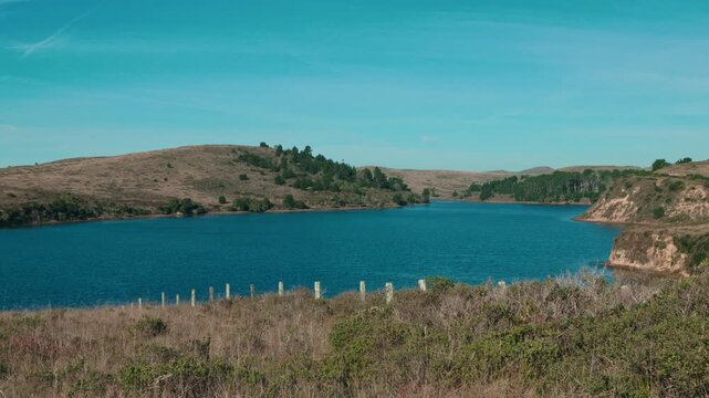 View of Abbotts Lagoon under a clear blue sky at Point Reyes
