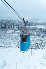 Tbilisi Aerial View with Blue Cable Car over Snowy Landscape