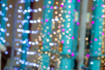 Out-of-focus blue, gold, and purple dots against teal columns create layered depth, ideal for promotional graphics, website headers, or presentation templates with bokeh effect focus