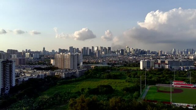 Dolly-Out Landscape Aerial of BGC Taguig Metro Manila in the Distance with Trees in the Foreground