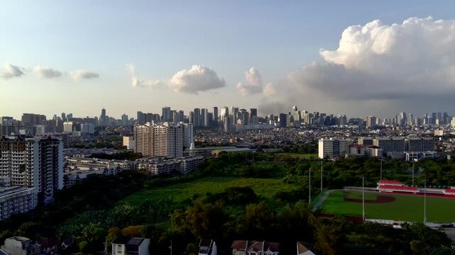 Boom-Up Landscape Aerial of BGC Taguig Metro Manila in the Distance with Trees in the Foreground