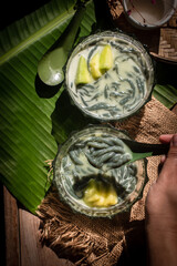 Traditional Thai dessert Lod Chong in glass bowls served with sweet coconut milk and jackfruit on...