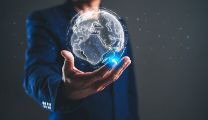 A person in a suit holds a glowing, digital globe, symbolizing connectivity and global awareness in a modern context.