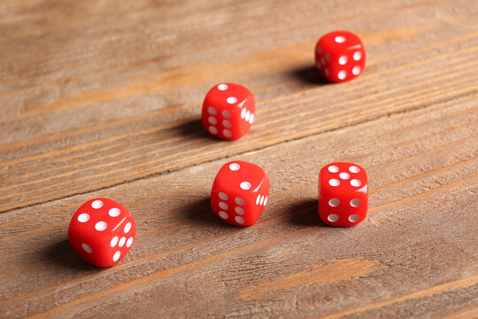 Red dices on wooden background