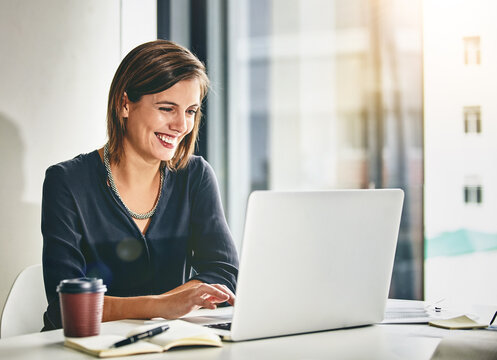 Laptop, happy and businesswoman in office with research for creative project with online feedback. Technology, smile and female magazine copywriter with computer for article publishing in workplace.