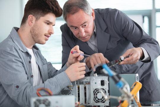 apprentice repairing computer in technical school