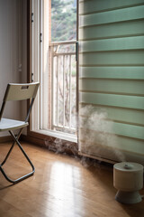 Cozy Room with Chair and Humidifier by Open Balcony Door