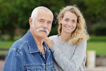 Fototapeta premium portrait of elderly man and young woman in the park