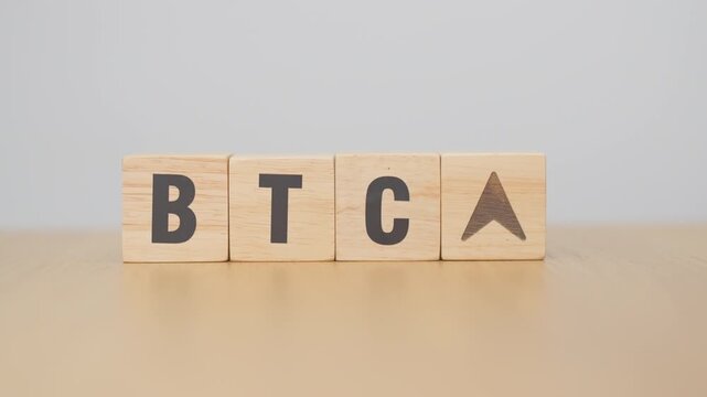 Hand change Wooden block with BTC or Bitcoin text to UP and Down arrow symbol. cryptocurrency, blockchain, price, down and up, decrease and increase, cut loss, trade and financial concepts