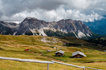Seceda mountain with traditional alpine huts in Dolomites, Italy